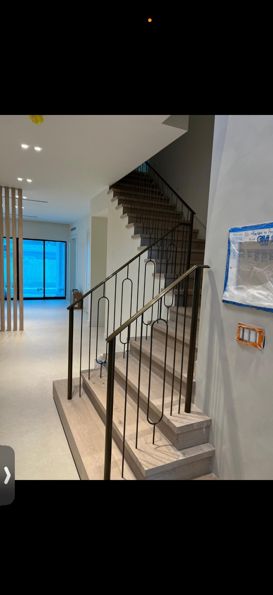 Oak stair with bronzed steel looped railing