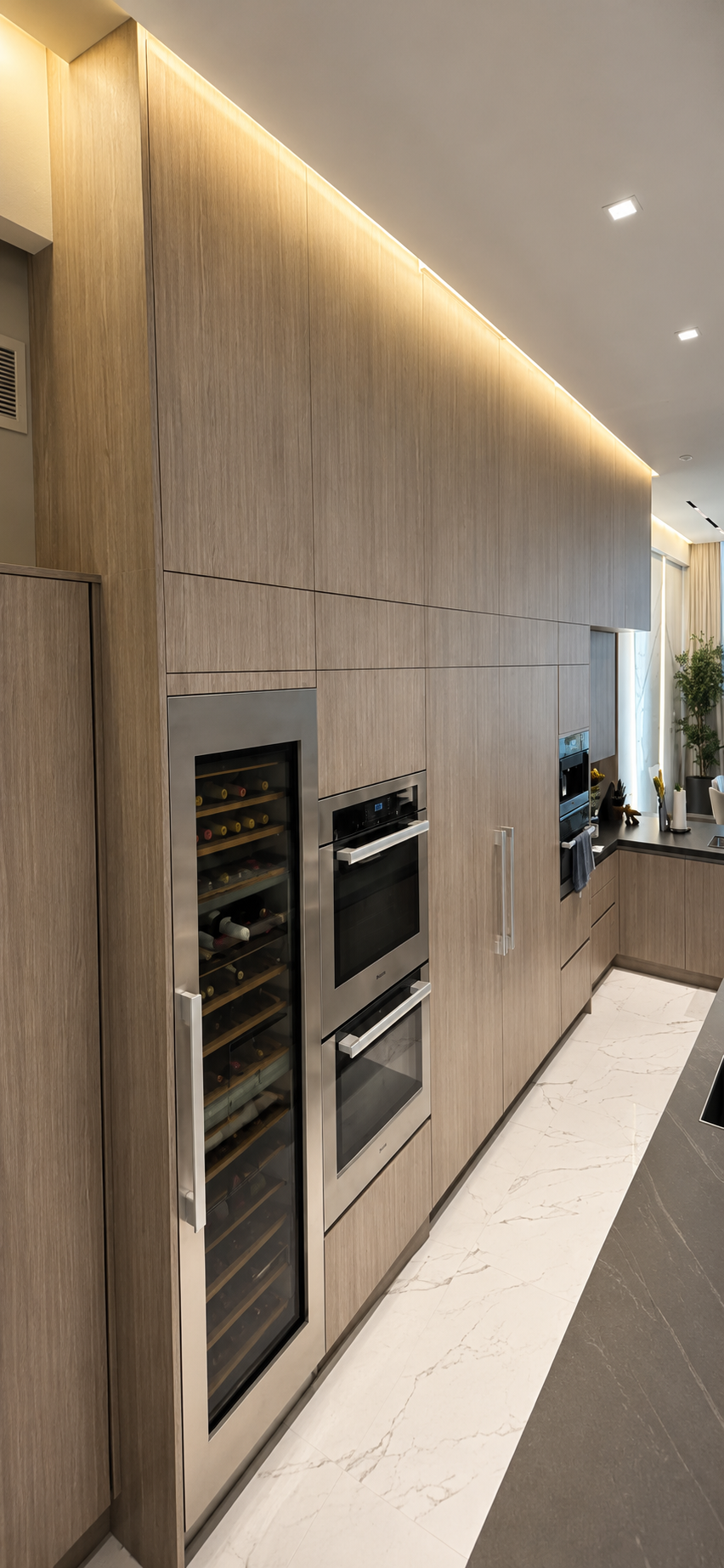 Full-height wood cabinetry with integrated wine column and ovens