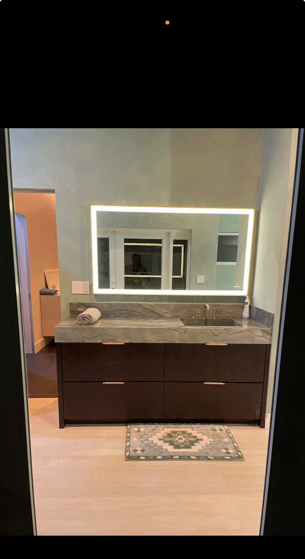 Guest bath with backlit mirror, quartzite top and espresso vanity